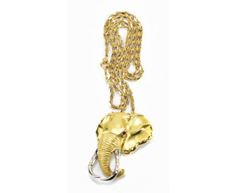 An 18ct textured yellow gold pendant in the form of an elephant's head, with ruby for eye and diamond set to the white gold t