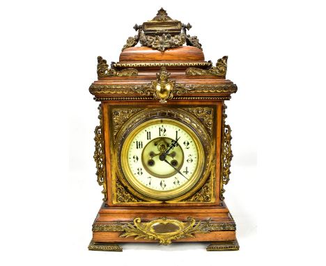 A late 19th century oak cased bracket clock with applied brass filigree decoration, the circular dial with Arabic numerals, h