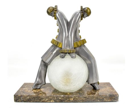 An Art Deco style desk lamp modelled as silvered pierrettes resting on a clear frosted shade, height 29cm.Additional Informat