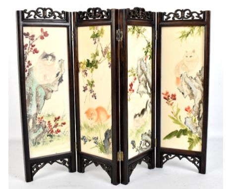 A small 20th century Chinese four panel folding screen set with painted panels depicting cats, height 36.5cm.