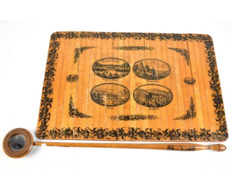 An unusual German pen work tambour roll with floral decorated border and central panel depicting six various town views, 35 x