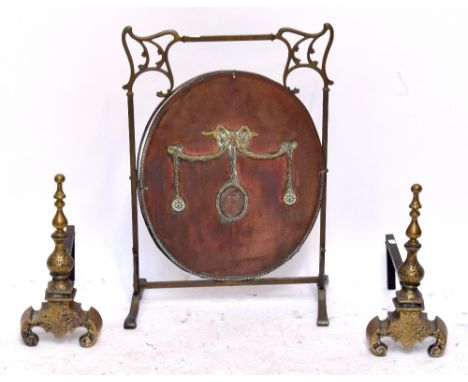 A brass Art Nouveau framed fire screen with later copper panel insert and a pair of andirons (3).