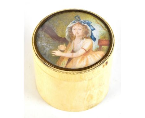 A 19th century ivory circular box, the cover painted with a lady playing the lyre, height 9cm, diameter 10cm (af).Additional 