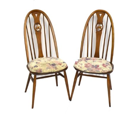 ERCOL; a set of four medium elm swan back dining chairs.