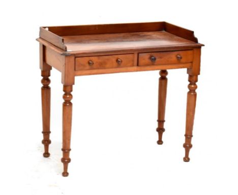 A Victorian mahogany console table, with two drawers raised on column supports, width 89cm.