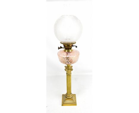 A Victorian brass Corinthian column oil lamp with pink reservoir, height 79cm.Additional InformationThe reservoir is dirty bu