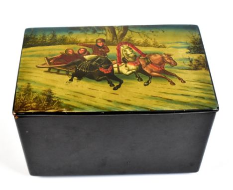 A Russian papier-mâché rectangular tea caddy, the lid decorated with a troika and bearing traces of stencil, dated 1882 to th