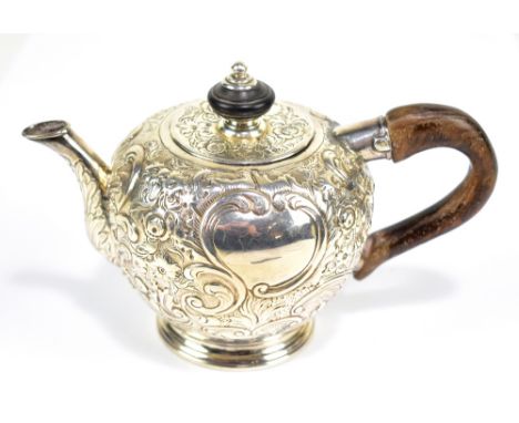 RICHARD FREEMAN; a rare George II English provincial bullet shaped teapot with later floral embossed decoration and wooden ha