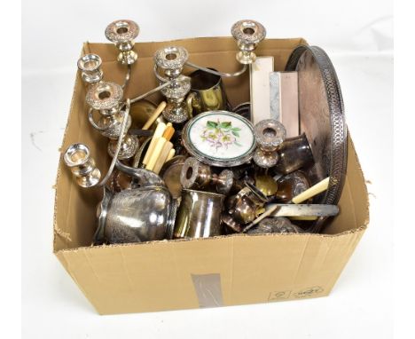 A quantity of silver plate including a pair of three branch candelabra, circular tray, candlesticks, mugs, teapot, etc.