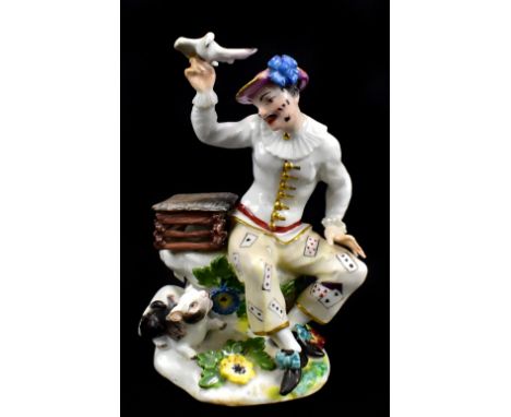 MEISSEN; a rare mid-18th century figure of a harlequin with a bird cage, bird in hand and cat by his feet, modelled by J. J. 