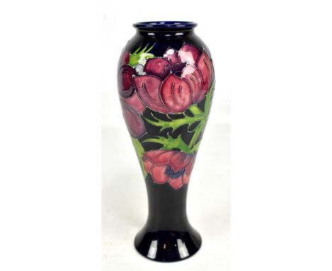 MOORCROFT; a tubeline decorated 'Anenome' pattern baluster vase on dark blue ground, impressed marks to base, height 27cm.Add