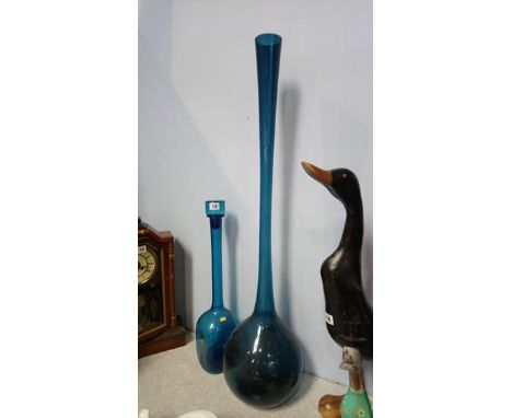 A large blue glass vase and decanter