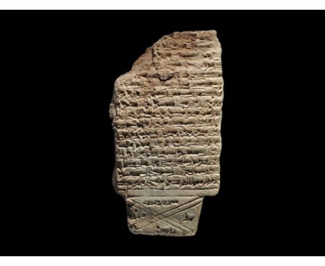 750-650 BC. A rectangular ceramic tablet with cuneiform text; accompanied by a copy of an old scholarly note, typed and signe