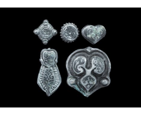 9th-12th century AD. A mixed group of silver mounts with niello ornamentation, comprising: one teardrop with beaded border; o