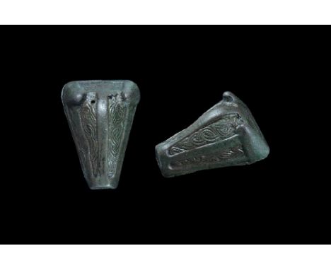 10th-11th century AD. A bronze boar-head brooch with separate backplate; the body formed as a hollow-cast case with upstandin