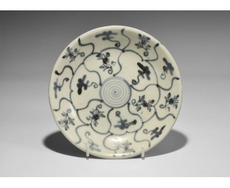 19th century AD. A shallow pale blue-glazed dish with basal ring, concentric blue segmented rings with floral motifs to inner