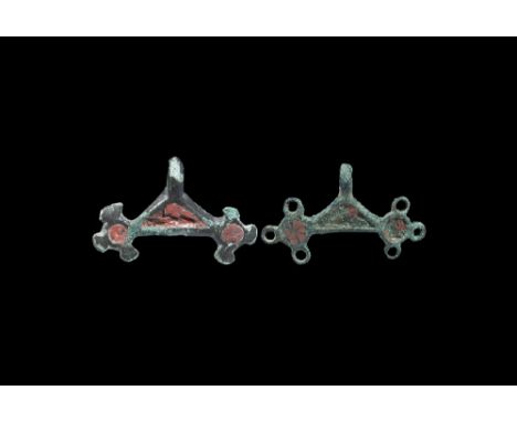 1st century BC-2nd century AD. A pair of bronze pendants, each formed as two discs each with three radiating lobes, one of lo
