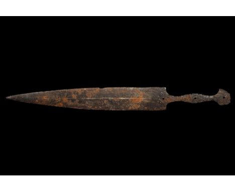 1st century AD. A hand-forged iron dagger with leaf-shaped blade, median fuller to each face, waisted tang punched to accept 