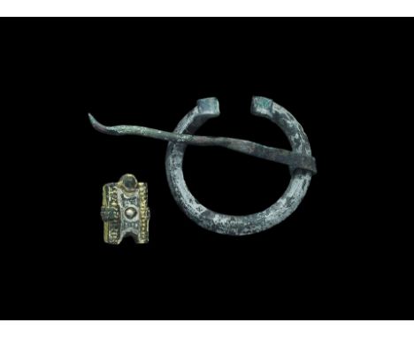 10th century AD. A mixed silver-gilt group comprising: a D-section penannular brooch with scrolled terminals, round-section p