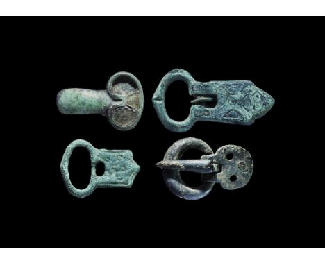 8th-12th century AD. A mixed group of bronze items comprising: two buckle plates with integral elliptical loop; a round-secti