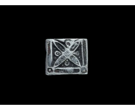 9th-12th century AD. A flat-section square silver mount fragment with central quatrefoil motif, interstitial lobes and linear