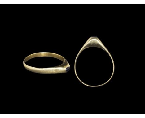 14th century AD. A narrow D-section gold hoop with triangular plaque, inset cabochon sapphire to the apex.    2.81 grams, 26m