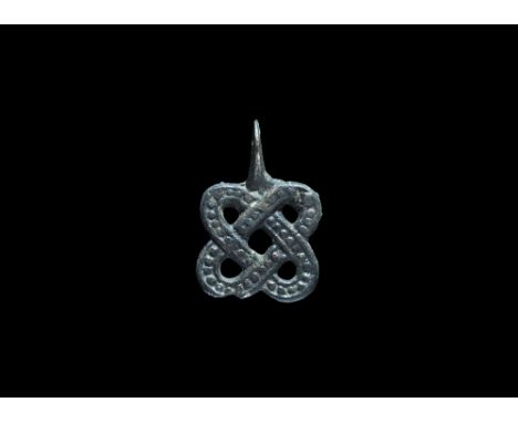 10th-12th century AD. A cast bronze Scandinavian type pendant formed as two beaded loops in cruciform arrangement, pierced lu