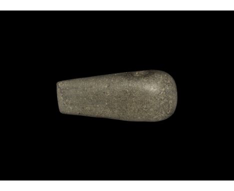Neolithic, 4th-mid 2nd millennium BC. A pecked and polished perforated axe of tapered form, in grey diorite.    468 grams, 13