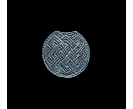12th-13th century AD. A domed patrix die or inlay mount with reserved latticework, ropework border; the style possibly origin