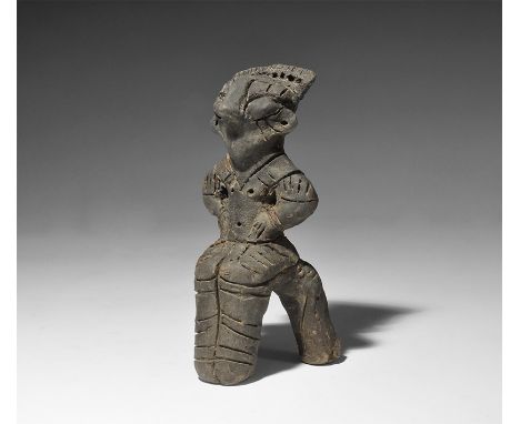 5th-3rd millennium BC. A ceramic figurine of a robed female seated on a chair, hands on the hips and arms akimbo; transverse 