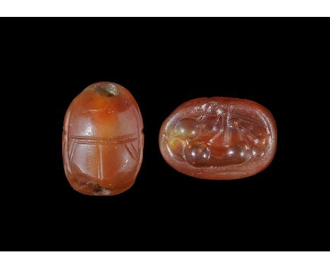 5th century BC. A carved scarab bead with intaglio motif to the underside of a kneeling warrior with sword, horsetail plume(?