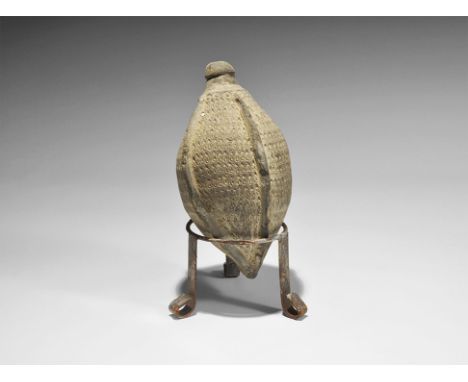 9th-11th century AD. A hollow ceramic biconical vessel with domed top intended to be filled with flammable liquid and a wick,