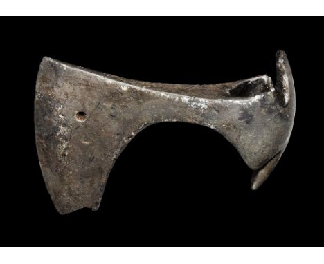 9th-11th century AD. A hand-forged iron axe head with scooped socket, broad blade with extension to the lower edge, hole to t