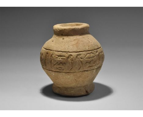 Late Period, 664-332 BC. A squat ceramic pot with discoid base and raised rim, band of incised hieroglyphic text to the equat