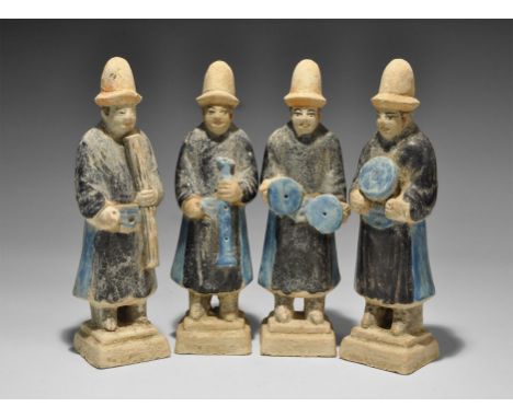 Ming Dynasty, 1368-1644 AD. A mixed group of glazed ceramic figurines, each a standing musician in conical brimmed hat and ro