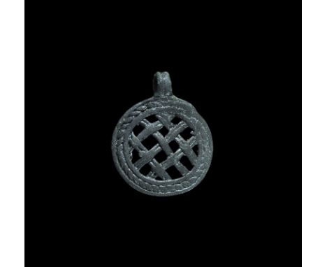 12th-13th century AD. A slightly dished discoid pendant with integral suspension loop; ropework border enclosing a panel of l