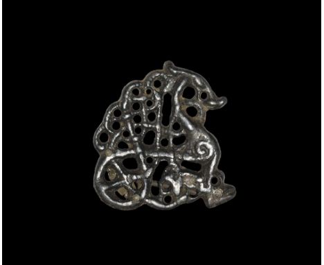 11th century AD. A very rare bronze openwork plate brooch with pin-lugs, pin and catchplate to the reverse; the plate an S-cu