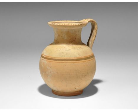 2nd century AD. A globular ceramic jug with tubular neck and flat everted rim, strap handle to the rear; concentric painted b