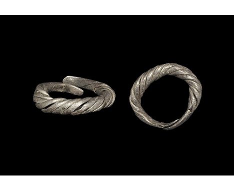 11th-13th century AD. A penannular hoop of expanding twisted billets with flattened finials; Baltic workmanship. Cf. Sedov, B