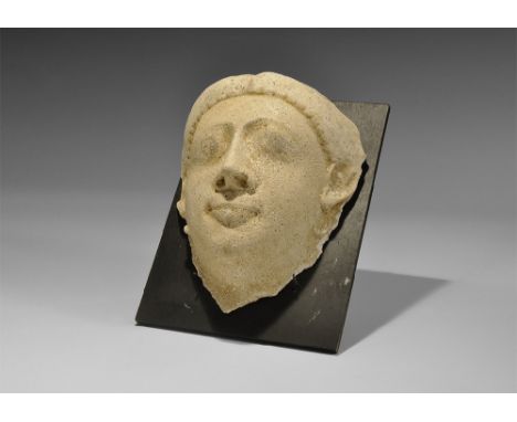 Romano-Egyptian Period, 30 BC-323 AD. A ceramic mask with finely modelled facial features, hollow to the reverse; mounted on 
