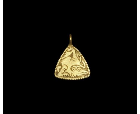 9th century AD. A triangular gold pendant with slightly convex edges and integral cast loop; the outer edges notched; the cen