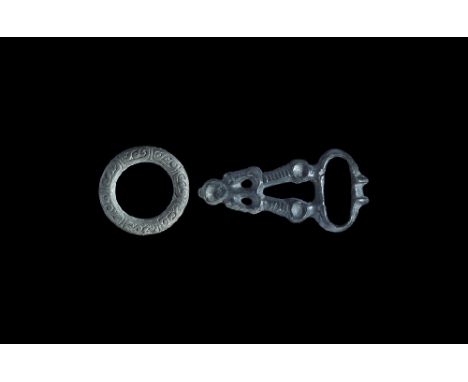 8th-12th century AD. A mixed bronze group comprising: a buckle plaque with kidney-shaped loop, triangular plaque with open ce