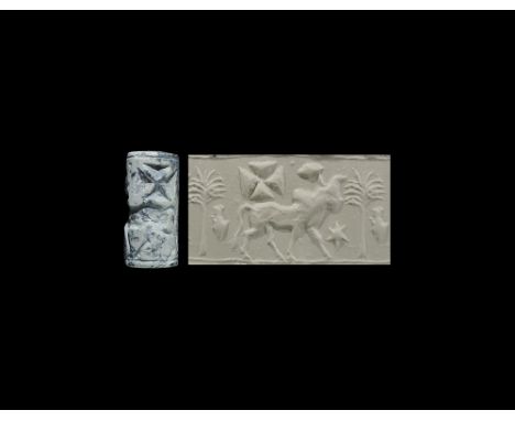 1100-1000 BC. A carved limestone seal with a bull and objects; accompanied by a typed and signed scholarly note issued by W.G