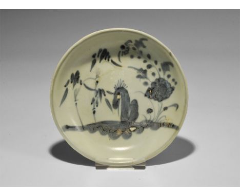 19th century AD. A shallow pale blue-glazed dish with basal ring, floral landscape, flowers and signature to the underside.  