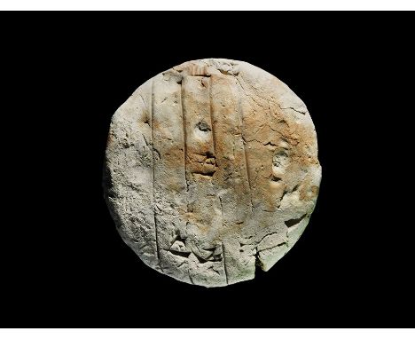 2100-1800 BC. A slightly domed ceramic disc with incised lines to both broad faces and Sumerian script; accompanied by an old