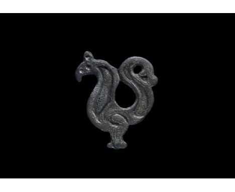 2nd century BC-1st century AD. A flat-section bronze appliqué with La Tène style lyre-shaped crescentic swirls forming a stan