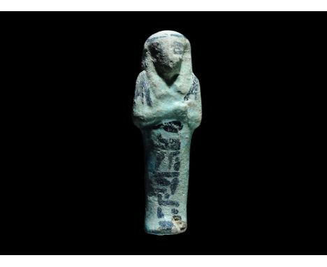 21st-22nd Dynasty, Third Intermediate Period, 1069-850 BC. A pale green glazed composition shabti with black pigment detailin