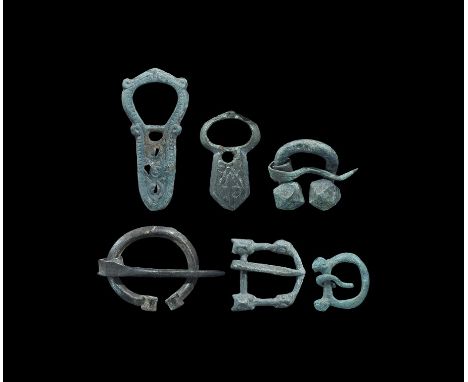 9th-12th century AD. A mixed group bronze items comprising: a penannular brooch with scroll finials; a penannular brooch with