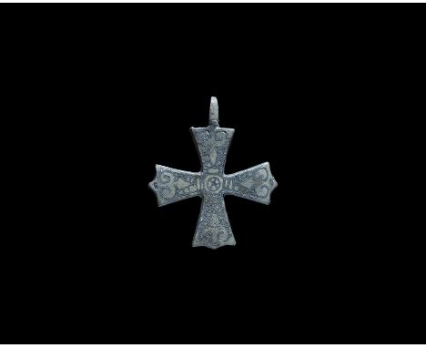 9th-12th century AD. A flat-section pendant with expanding arms, integral loop above, reserved scroll and ladder patterns in 
