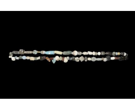 1st millennium BC. A restrung necklace of beads of tubular, globular, biconical and other profiles in glazed composition, gla
